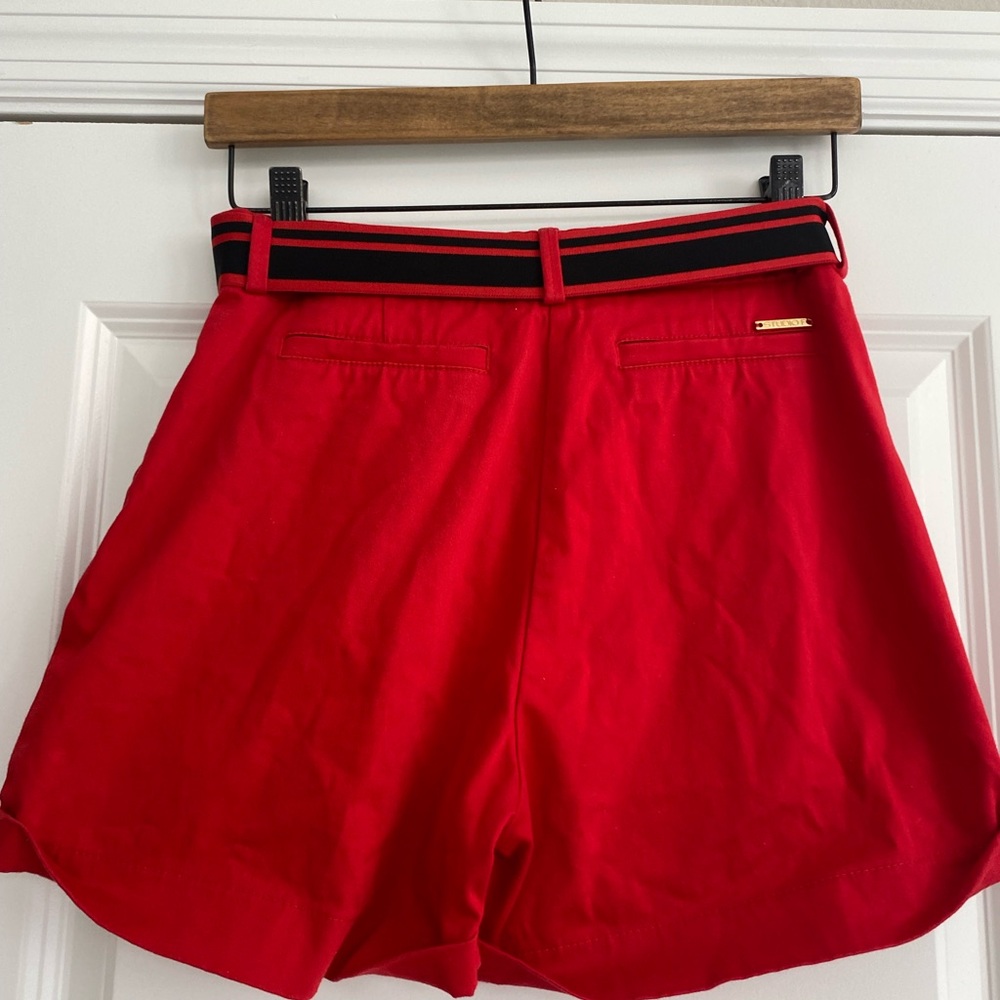 Studio F red shorts with belt .